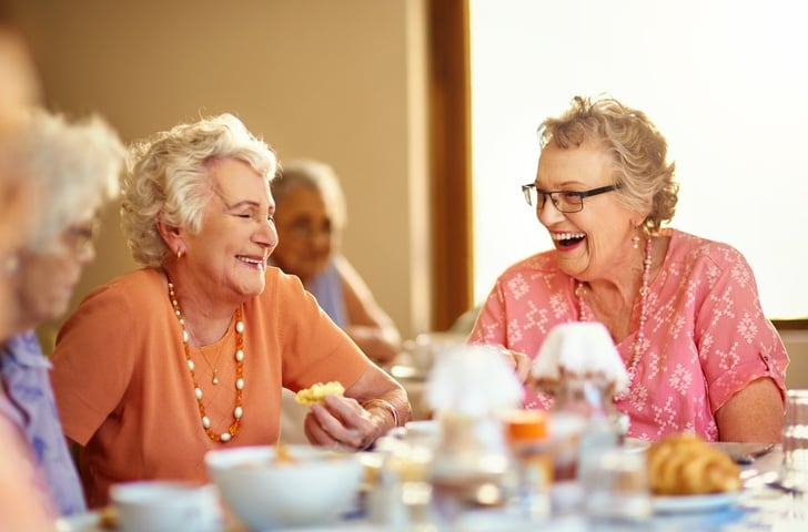 elderly women enjoying a meal in an assisted living community