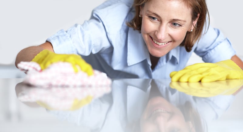 cleaning lady whipping off a glass table