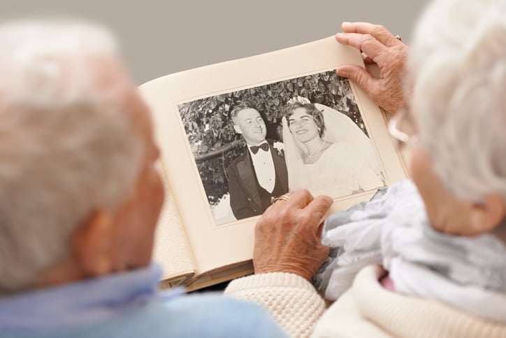 an older couple looking through a photo album