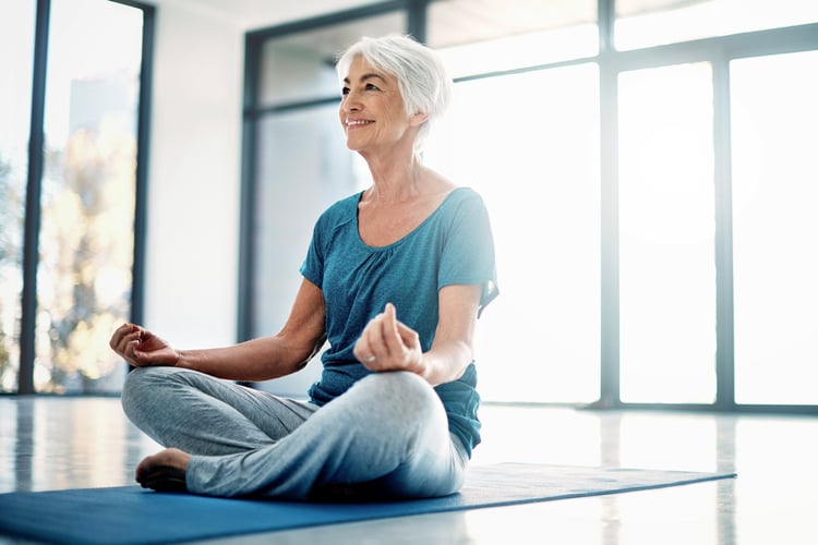 Senior woman doing yoga wondering if a holistic approach to healthcare really makes a difference