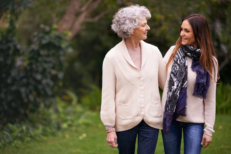 Caregiver child talking with senior parent about assisted living