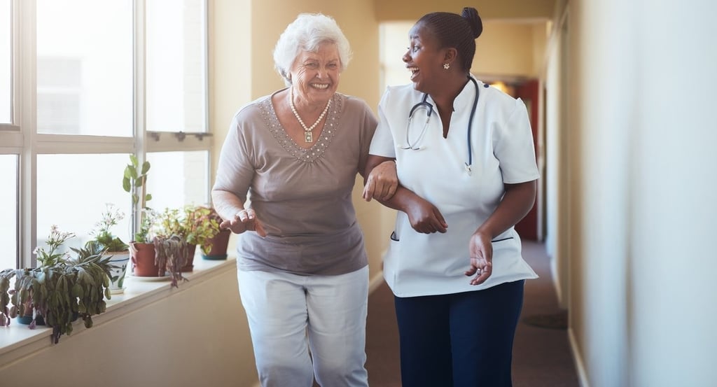 Caregiver and senior discussing assisted living facilities
