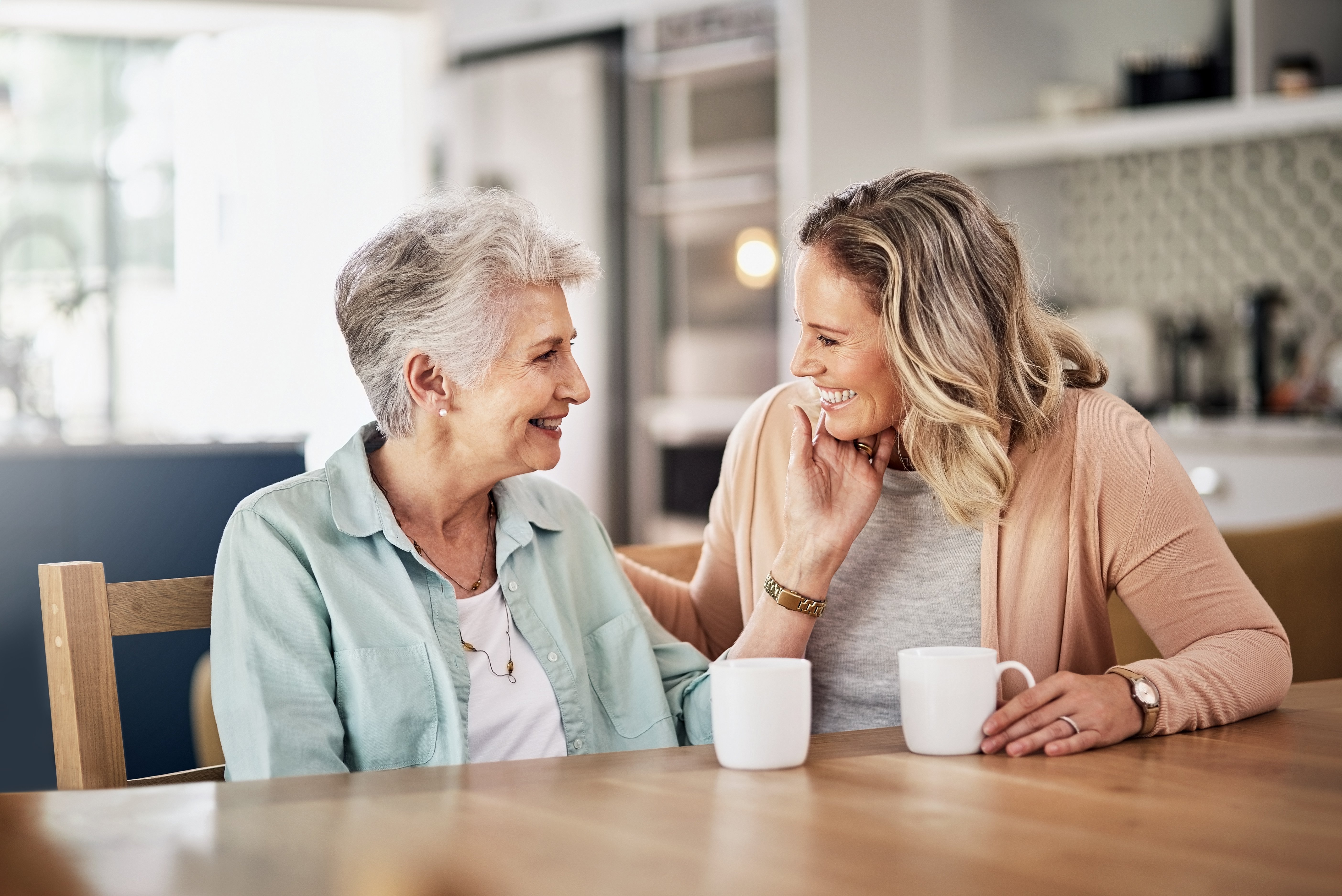 Mother and daughter enjoying a cup of coffee together