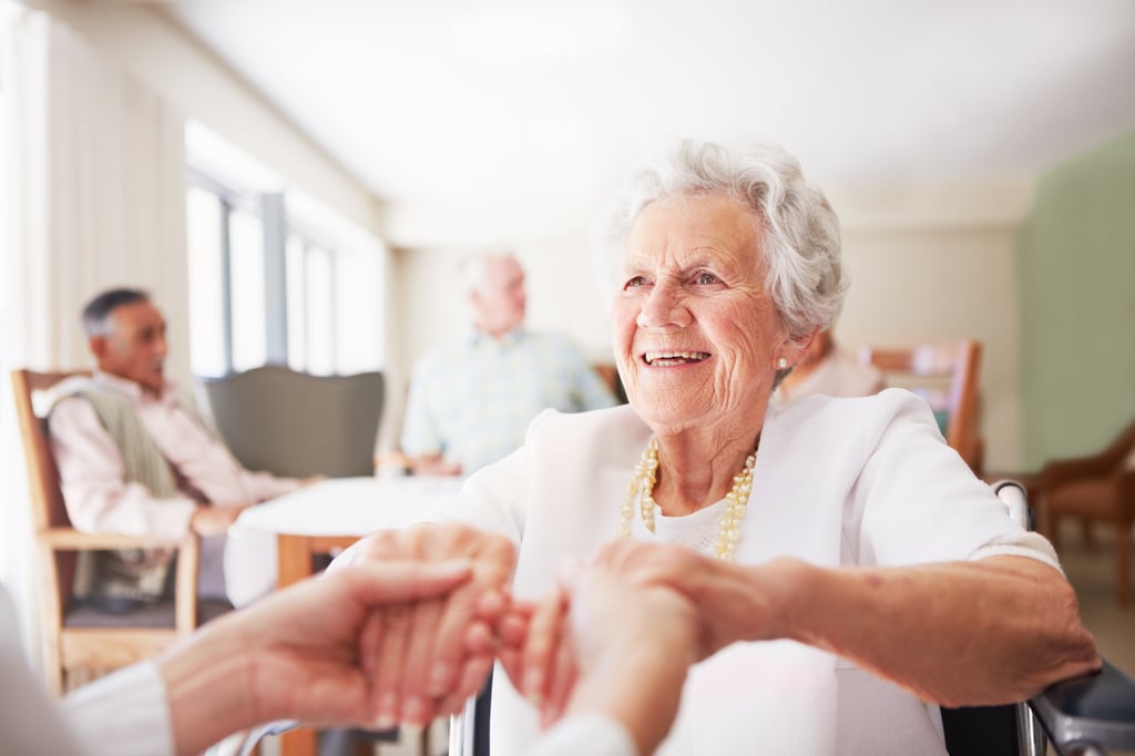 Senior woman in assisted living community working with an individual who is advocating for holistic health care