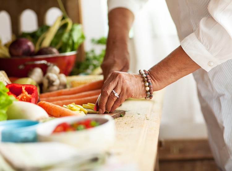 Senior cutting vegetables for a healthy and nutritious meal