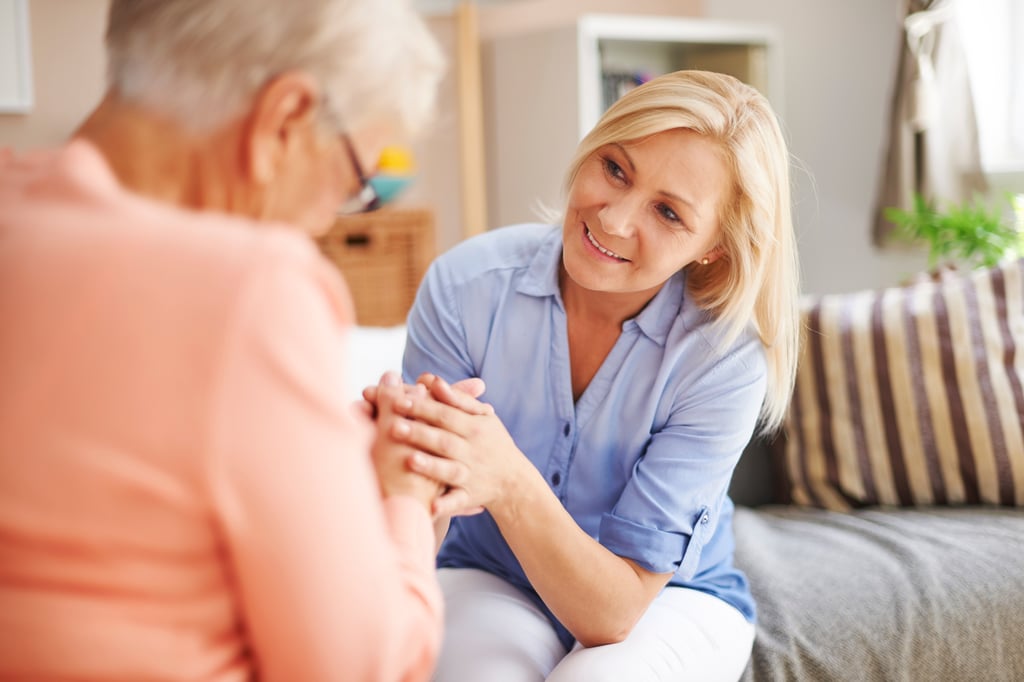Adult child talking with senior parent about respite stay