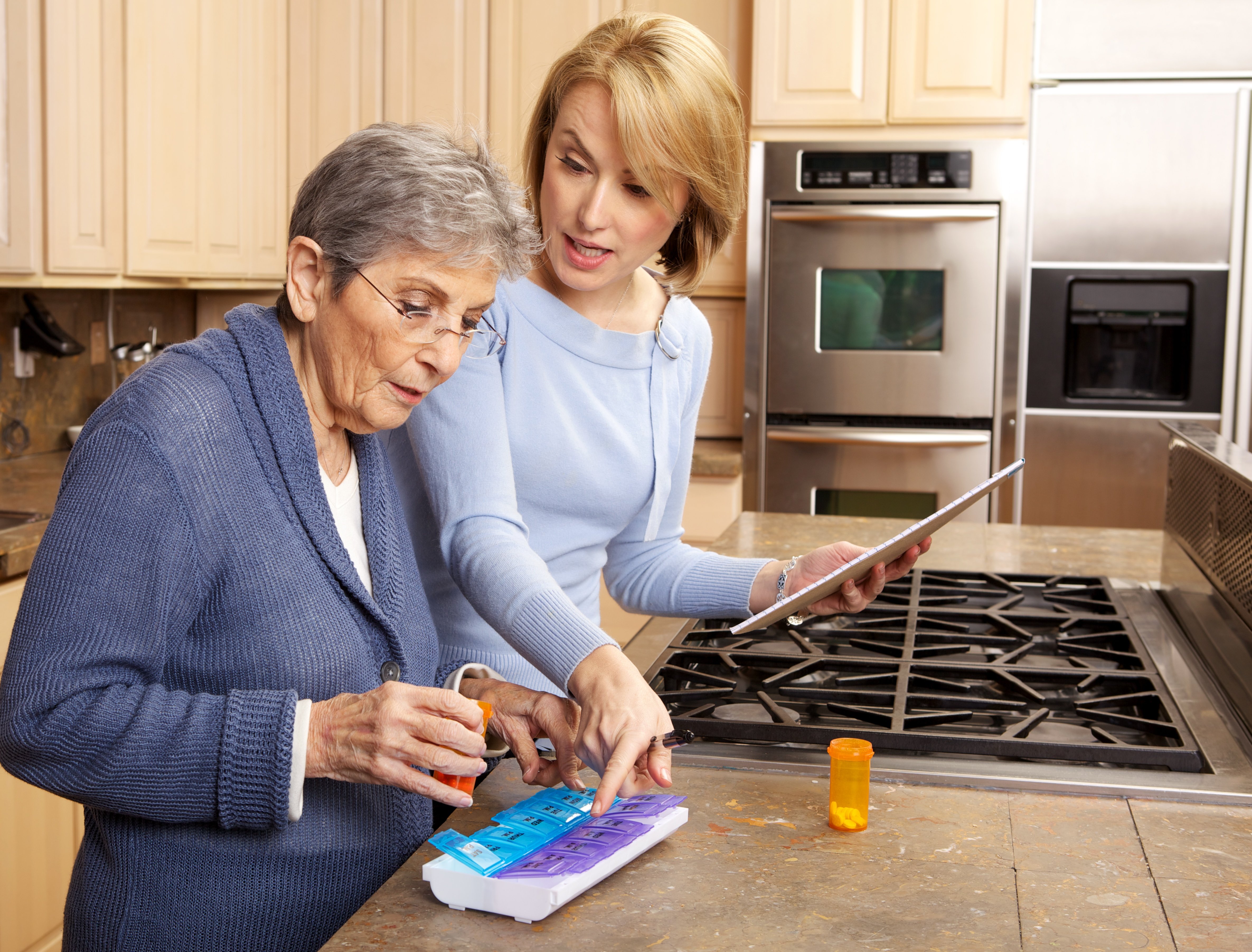 Family caregiver managing medications for a parent with dementia