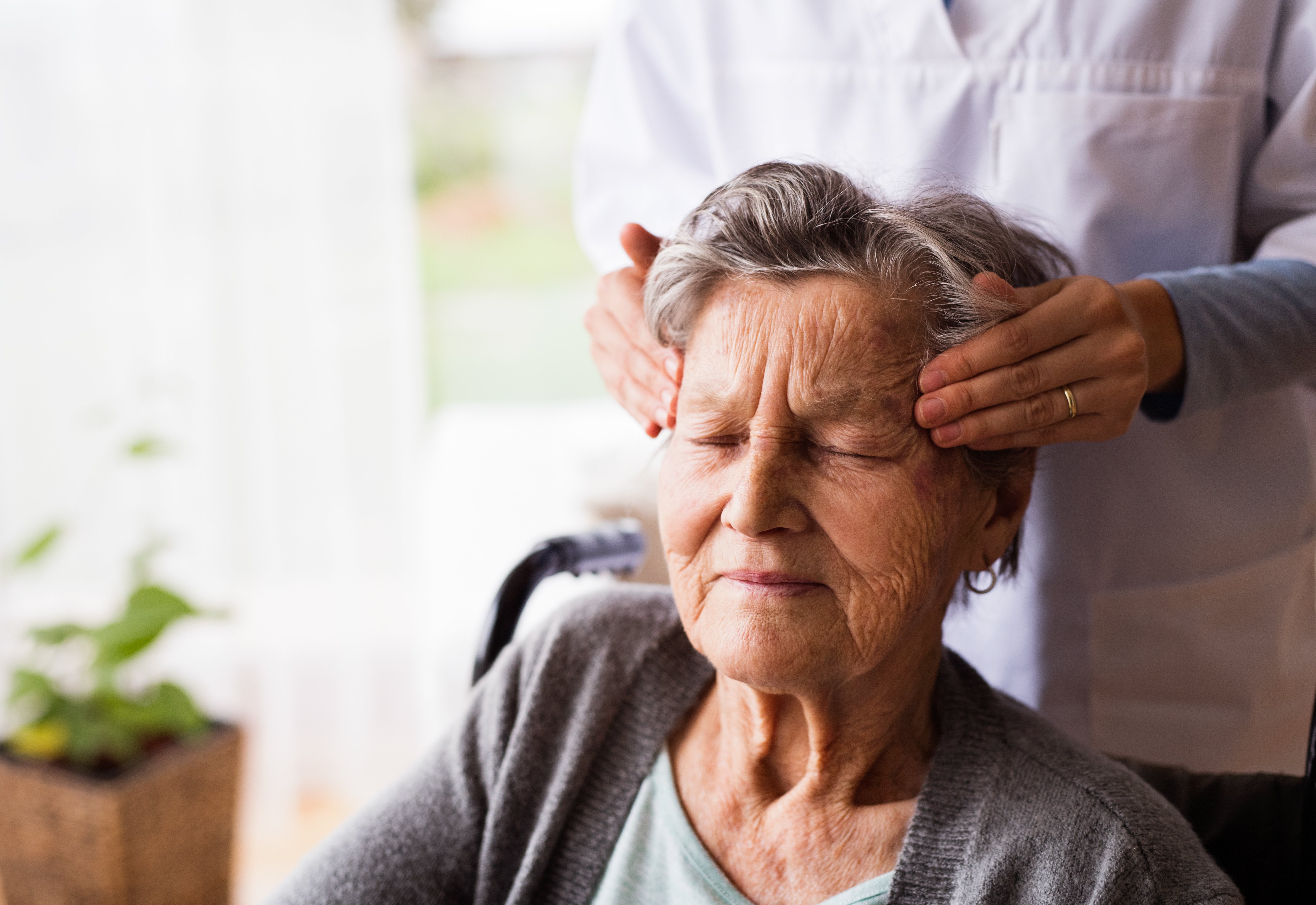senior woman experiencing chronic pain getting a massage to reduce use of medication