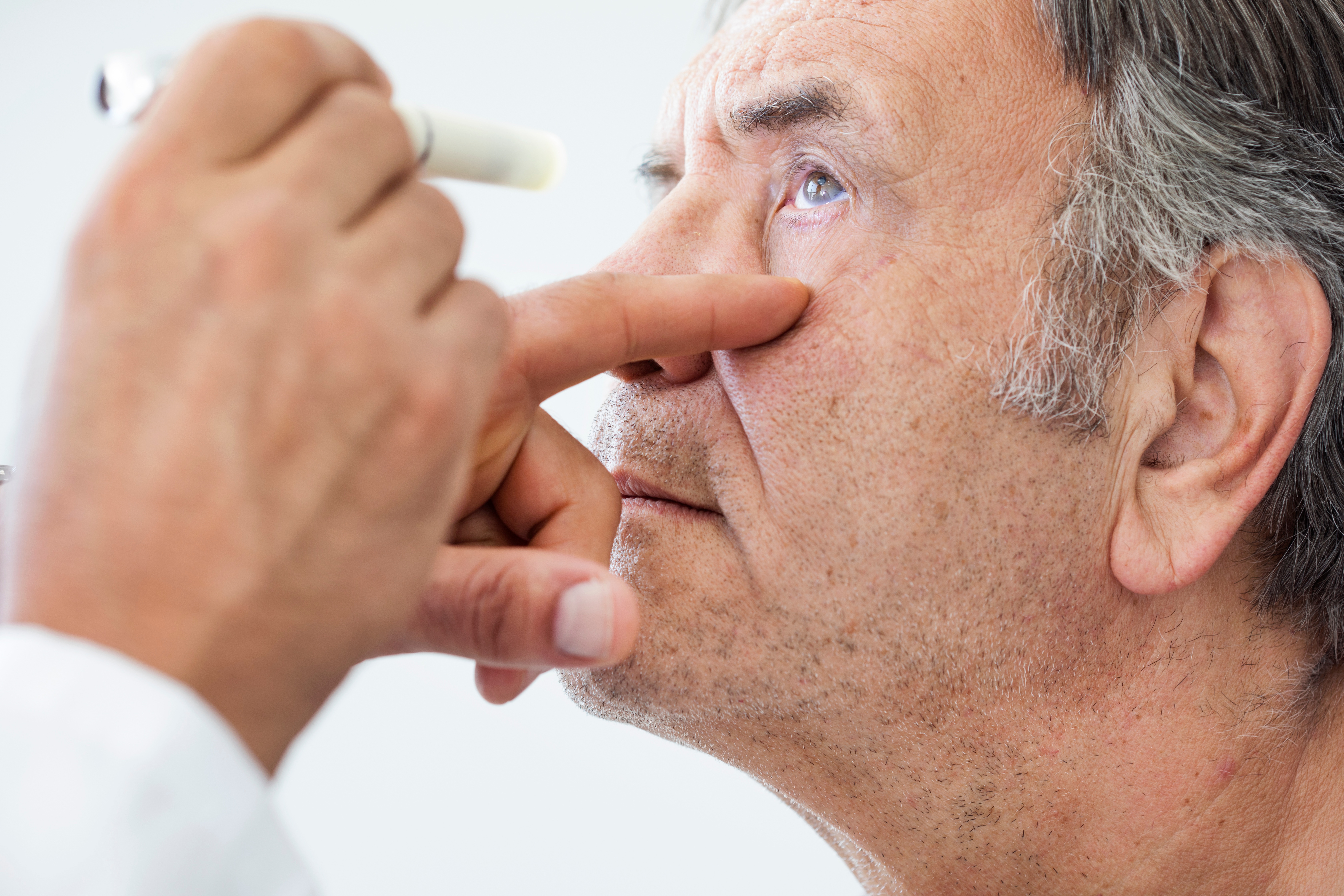 Senior man getting eye exam to prevent vision loss