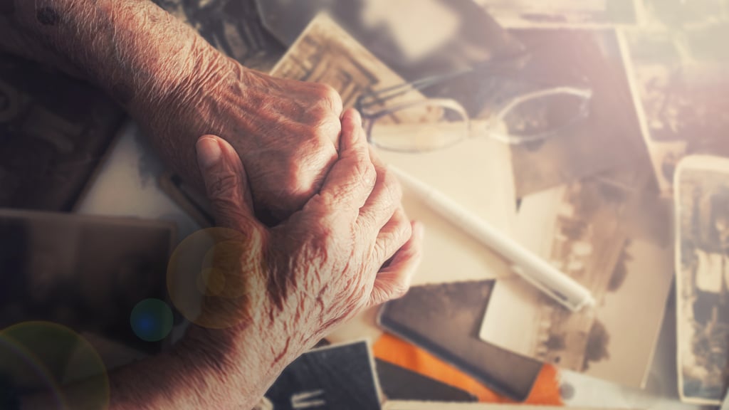 Senior woman with dementia looking through old photos wondering what to ask about dementia care facilities