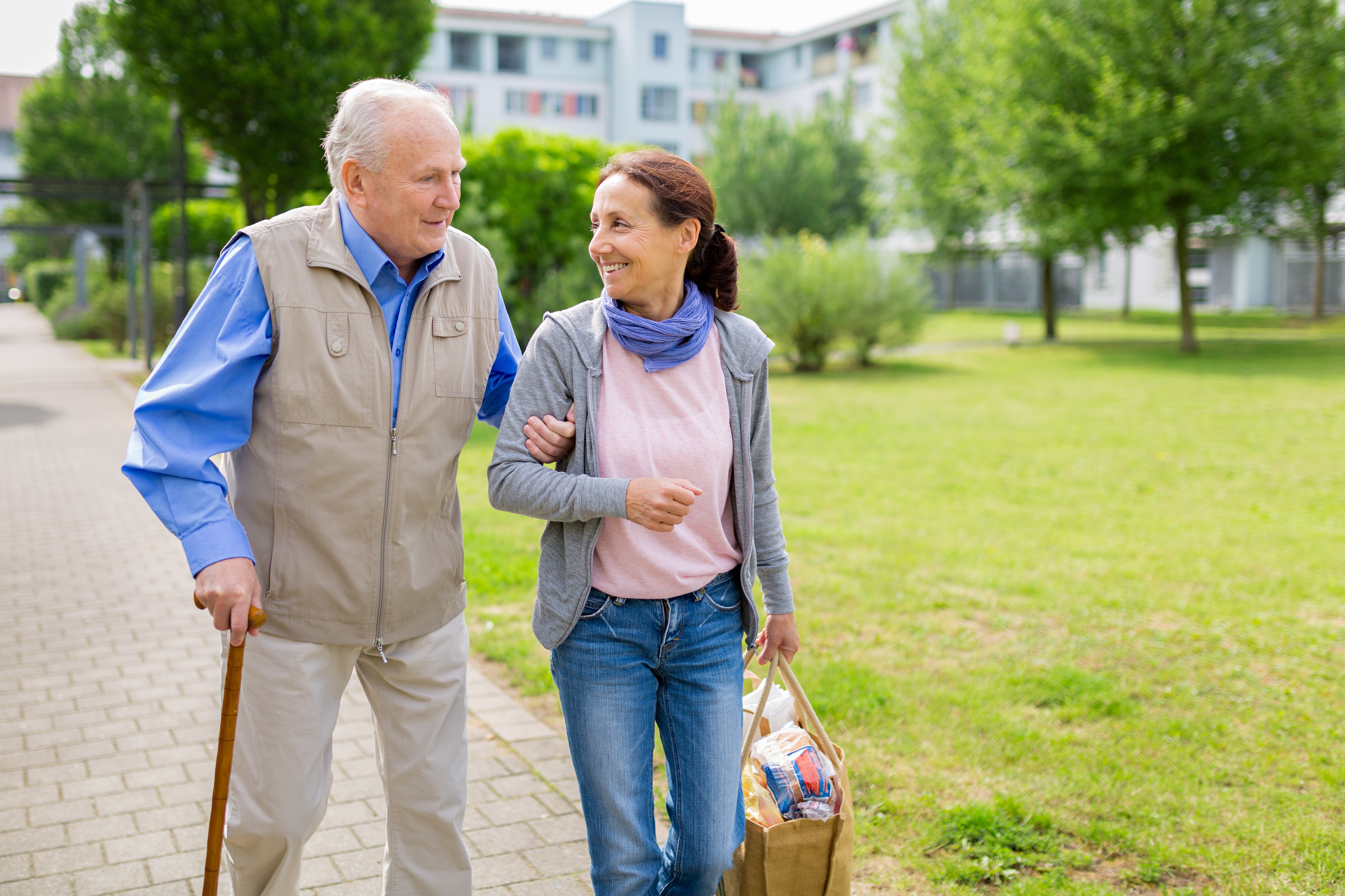 older adult couple going for a walk to decrease falls and improve mobility