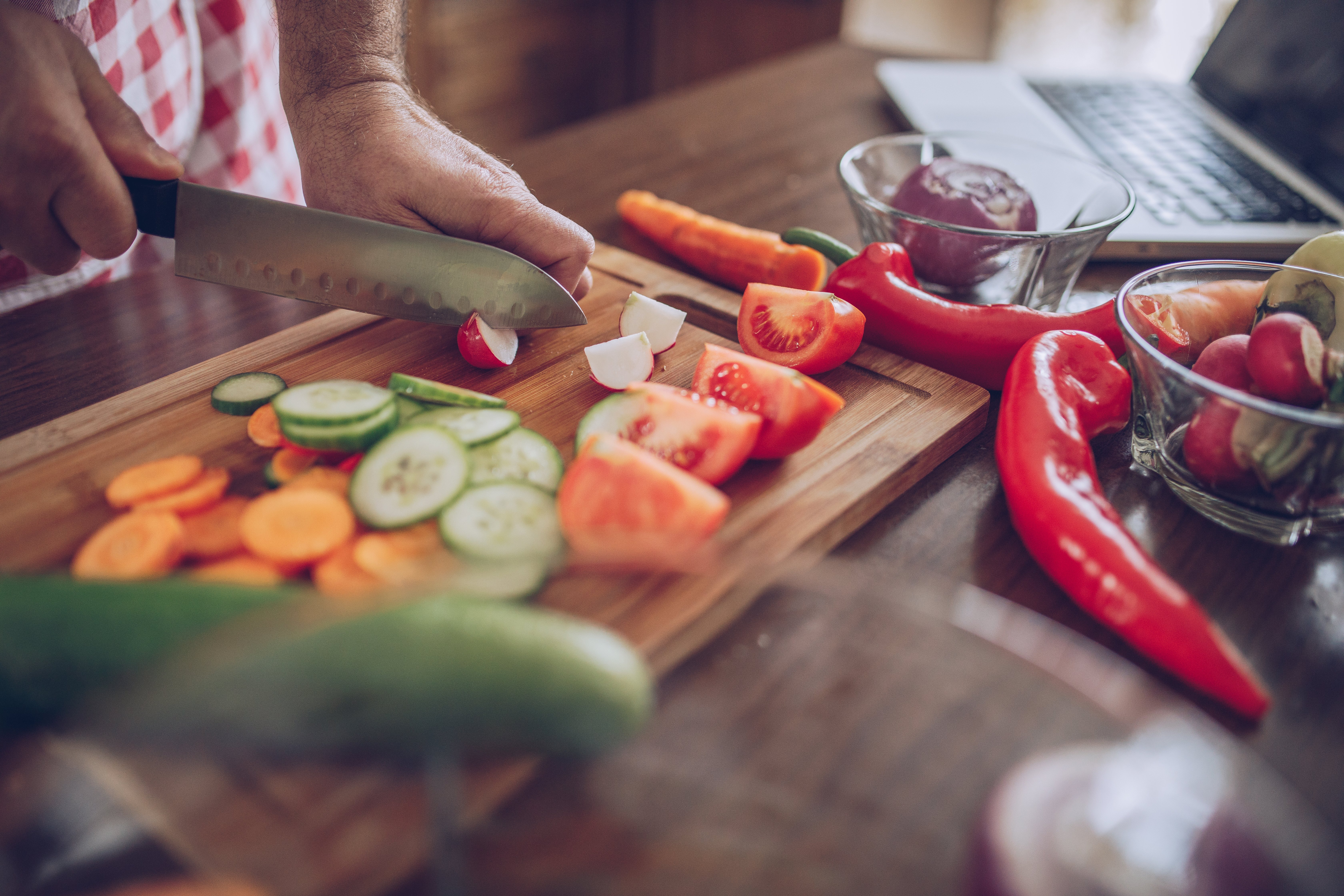 A chef cutting up some healthy foods/veggies