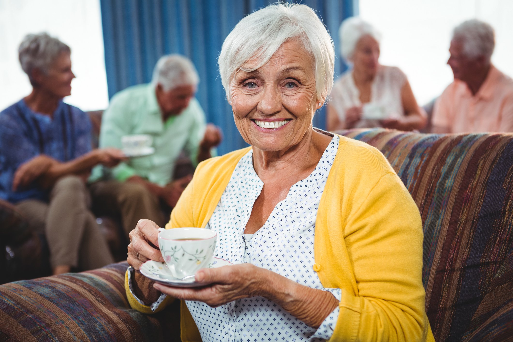 Resident enjoying a cup of coffee in the company of others