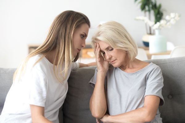 Mother and daughter having a serious conversation on the couch