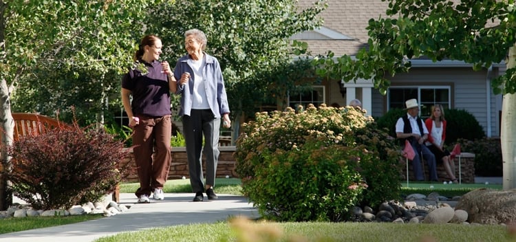 Temecula CA memory care provider walking with a memory care resident