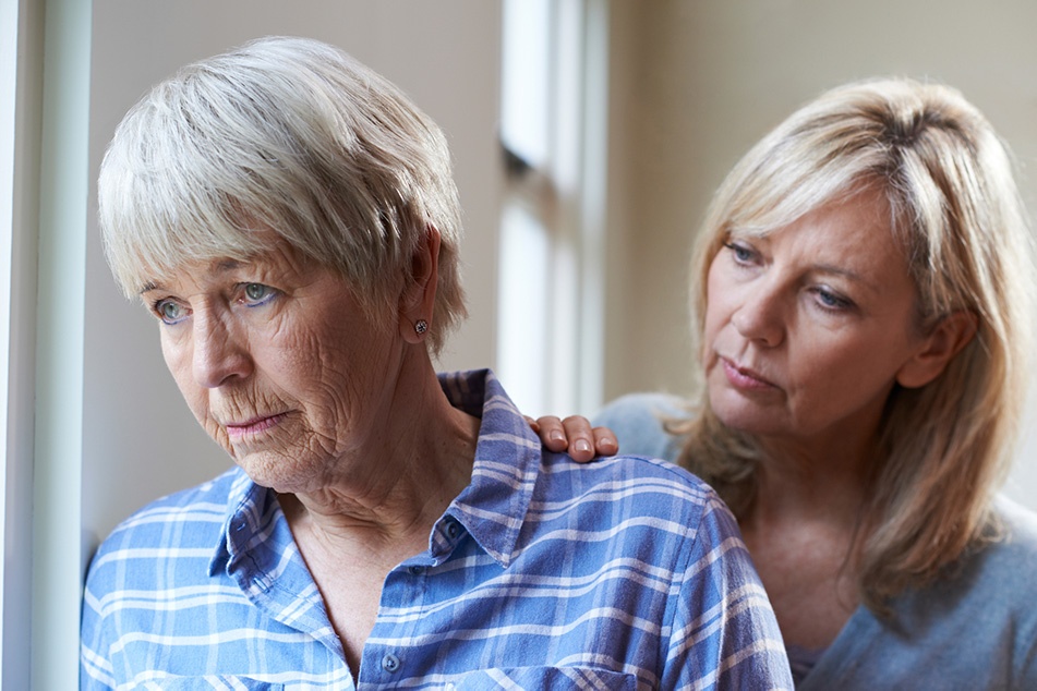 Adult woman concerned about elderly mother