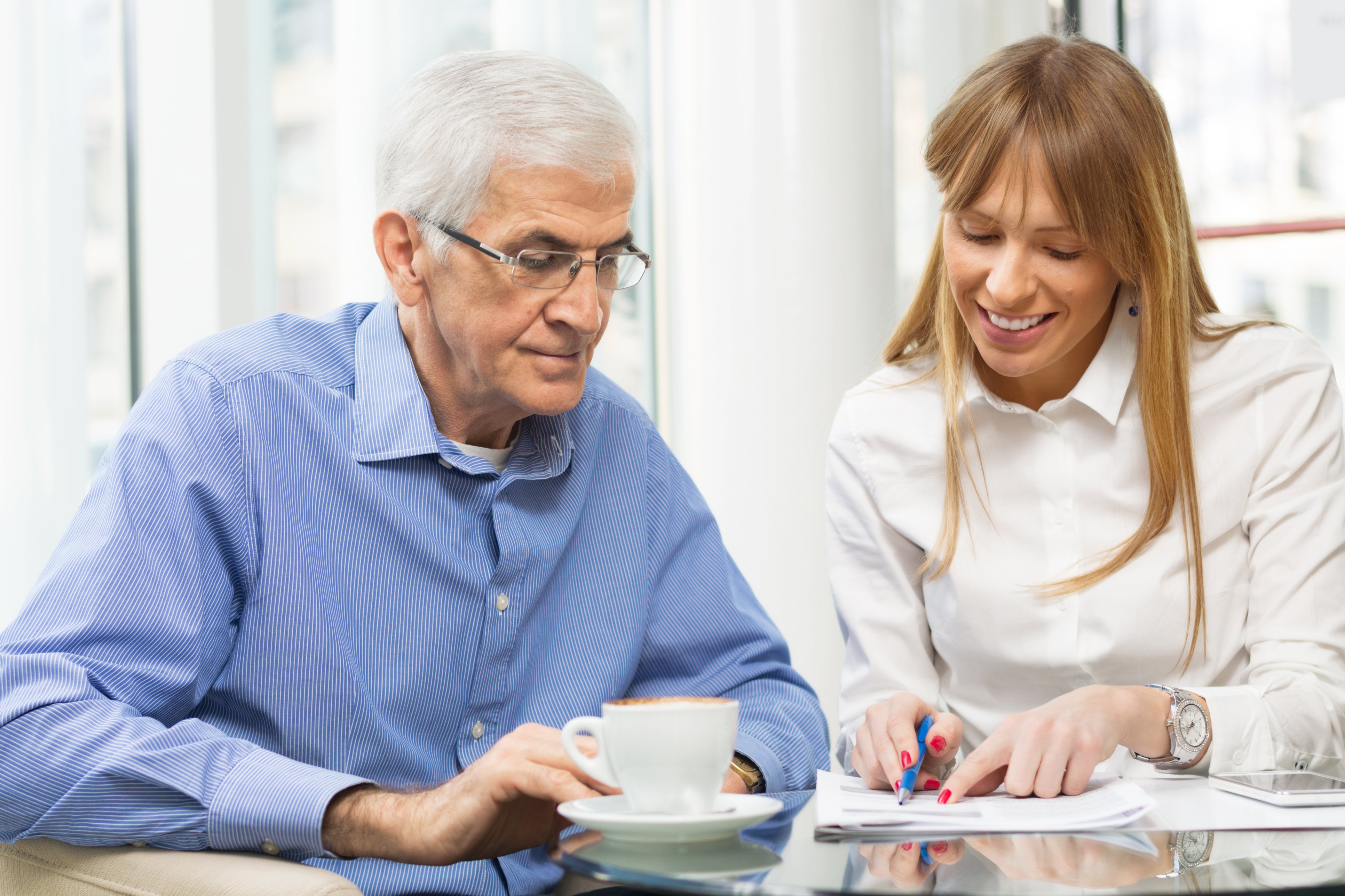 health professional helping an elderly man go through paperwork