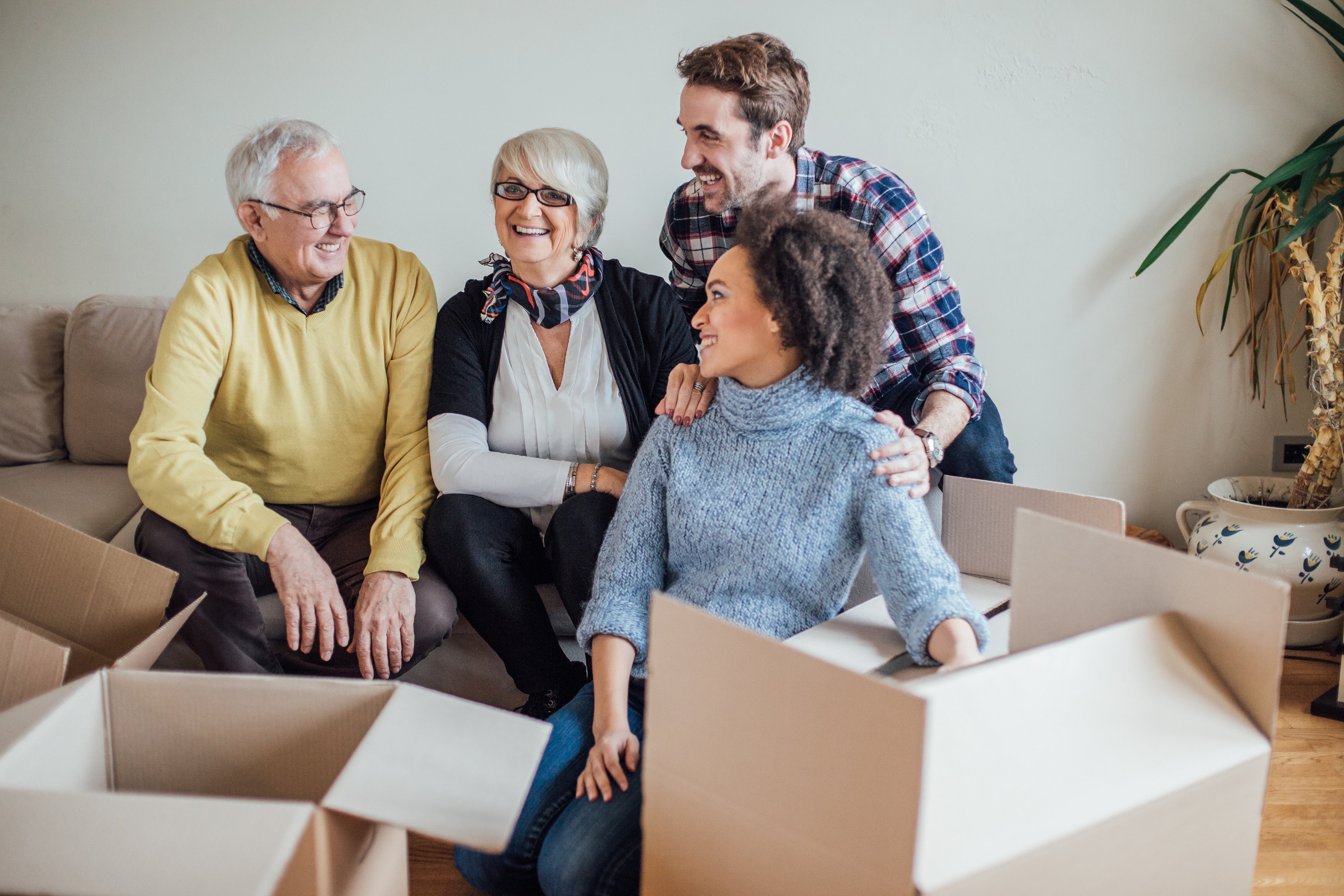 Family packing boxes together while laughing with one another