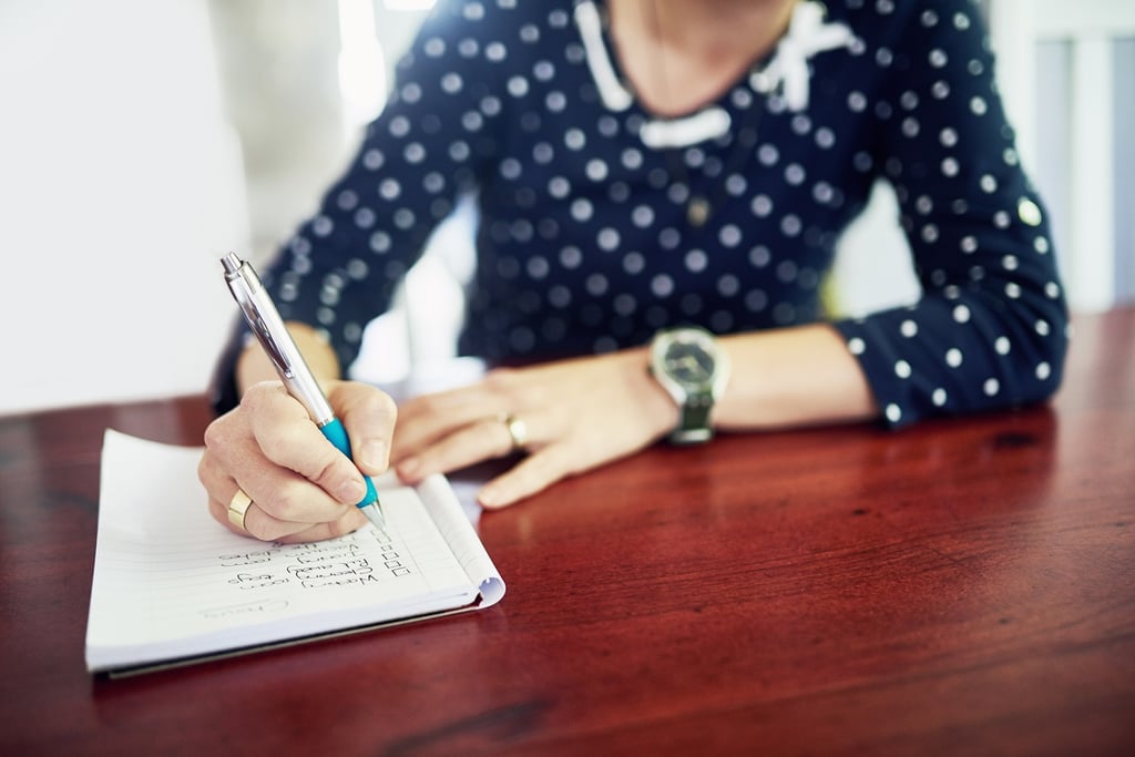 adult child making a list of questions to ask when visiting a memory care facility