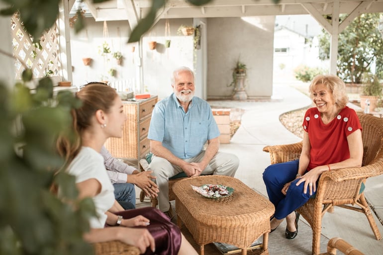 a daughter talking with elderly parents