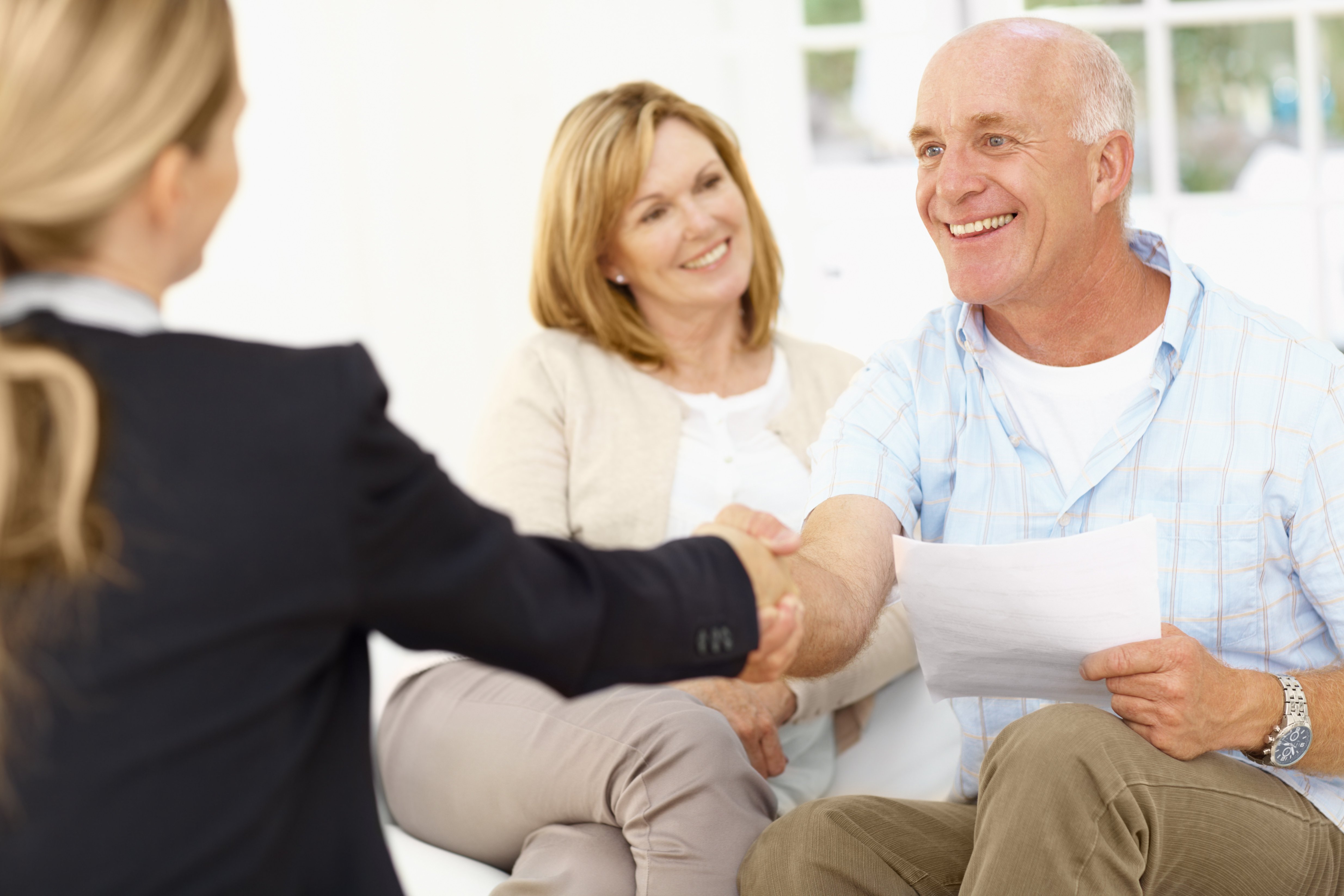 Couple talking with a Real Estate Agent